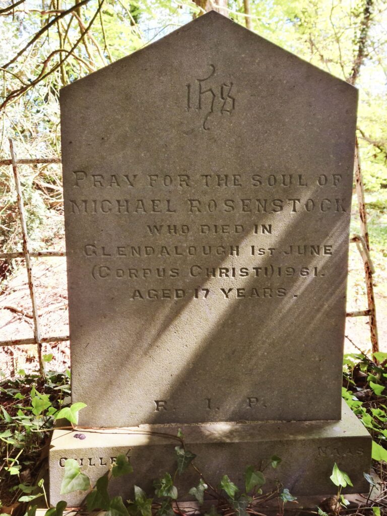 Granite headstone inscribed: IHS Pray for the soul of Michael Rosenstock who died in Glendalough 1st June (Corpus Christi) 1961. Aged 17 years. 